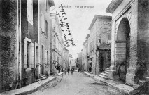 Donzère.- Grande Rue à droite la tour de l'Horloge.