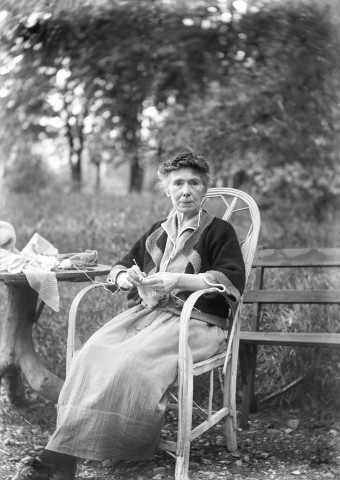 Charols, château de Salettes. - Marie Champin cousant, assise dans le jardin.